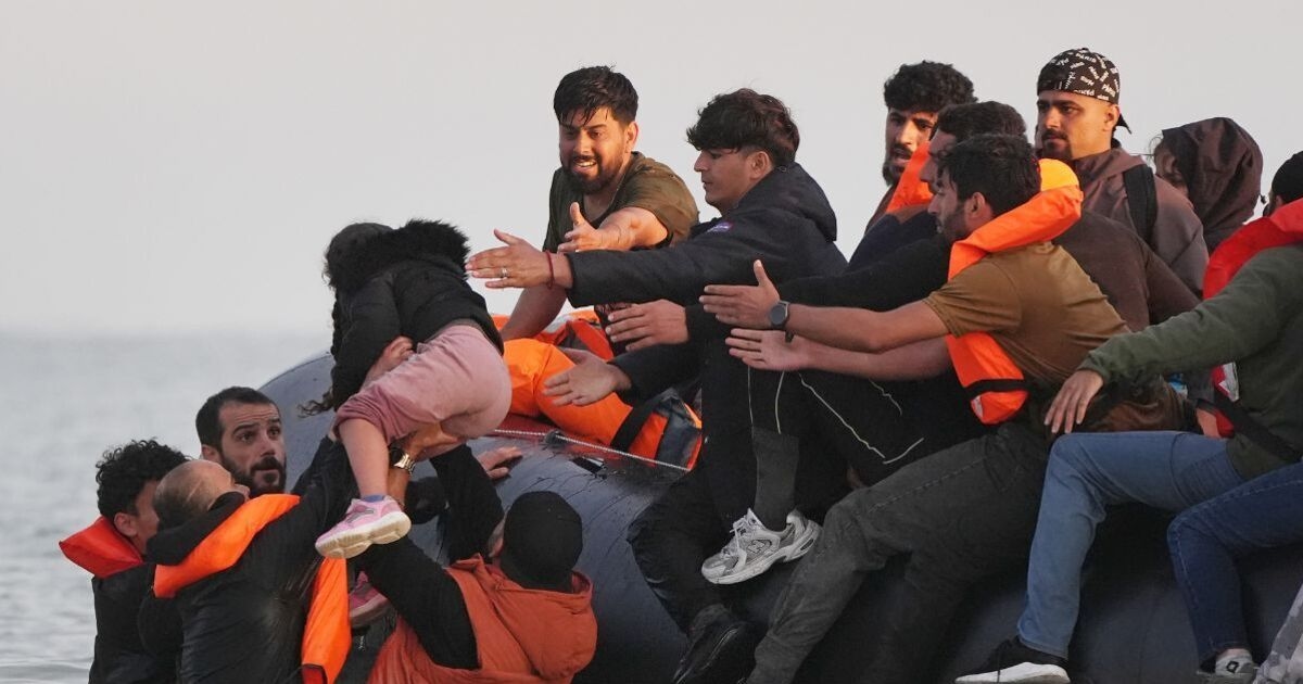 Unbelievable moment dozens of migrants charge into Channel in desperate bid to reach UK