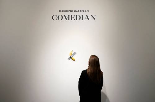 Visitor bit into banana stuck to a wall at the Pompidou, by Maurizio Cattelan